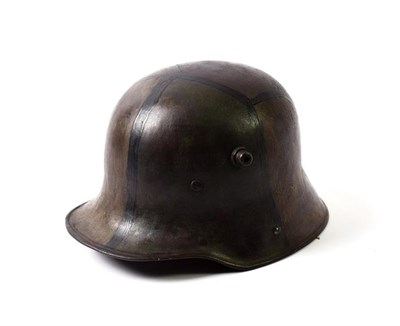 Lot 2149 - A First World War German M1916 Helmet (Stahlhelm), with painted camouflage, the left inner brim...