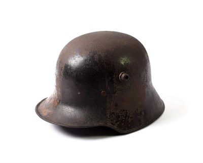 Lot 2150 - A First World War German M1916 Helmet (Stahlhelm), with traces of painted camouflage, with...