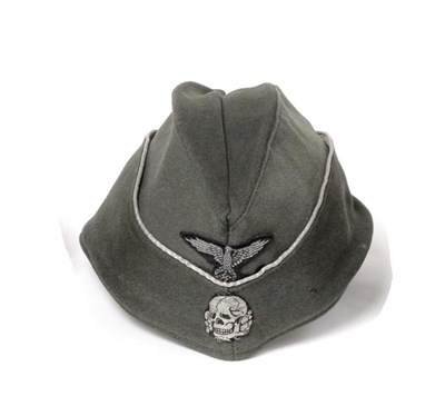 Lot 2161 - A German Third Reich SS Officer's Overseas Cap, in field grey wool mix, the fold-down sides...