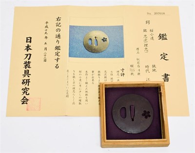 Lot 2188 - A Japanese Iron Maru Gata Tsuba, with ko-sukashi of a sakura flower, signed,  7.1cm, in wood...