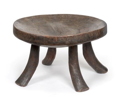 Lot 2285 - A 19th Century Ethiopian Chief's Stool, the deeply concave circular seat set with an old paper...