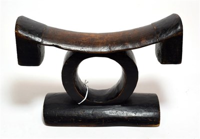 Lot 2287 - An Early 20th Century Zulu Headrest, of dark patinated wood, the curved rectangular top with...