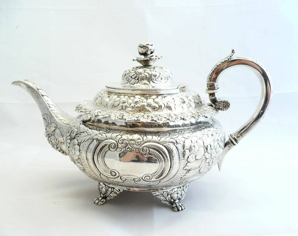 Lot 350 - A George IV Irish Teapot, James Fray, Dublin 1826, of compressed circular form on four paw and...