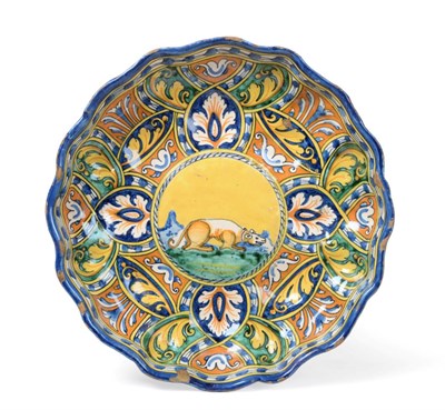 Lot 20 - A Faenza Maiolica Crespina, circa 1550, of lobed circular form, painted in colours with a recumbent