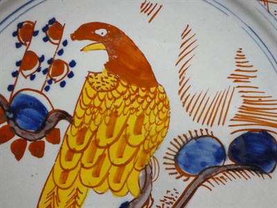Lot 21 - A Pair of Dutch Delft Pancake Plates, 18th century, painted in colour with parrots perched in...