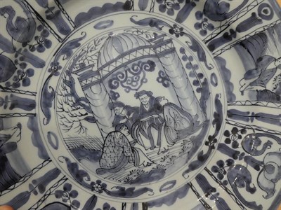 Lot 22 - A Dutch Delft Dish, late 17th century, painted in blue in Kraak style with central European figures