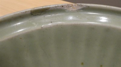 Lot 30 - A Longquan Celadon Dish, Ming dynasty, carved with a central foliate panel within a broad...