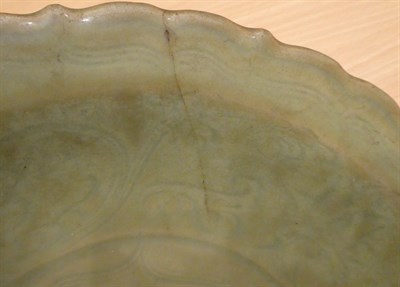 Lot 31 - A Longquan Celadon Dish, Ming dynasty, carved with lattice and scrolls within an Arabesque...