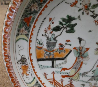 Lot 44 - A Chinese Porcelain Charger, Kangxi, painted in famille verte enamels with figures in a fenced...