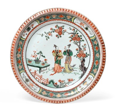 Lot 49 - A Chinese Porcelain Charger, Kangxi, painted in famille verte enamels with figures in a fenced...