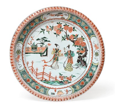 Lot 50 - A Chinese Porcelain Charger, Kangxi, painted in famille verte enamels with figures in a fenced...