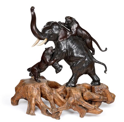 Lot 79 - A Japanese Bronze Large Okimono, Meiji period, as an elephant being attacked by two tigers, the...