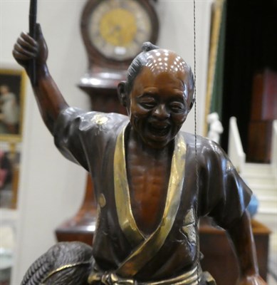 Lot 80 - A Japanese Gilt and Patinated Bronze Figure of a Fisherman, Meiji period, in the manner of...