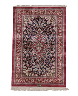 Lot 248 - Ghom Silk Rug Central Iran, late 20th century The indigo field richly decorated with flowing...