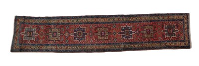 Lot 251 - Narrow Heriz Runner North West Iran, circa 1920 The terracotta field with a column of...