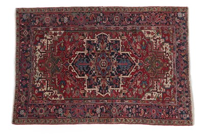 Lot 260 - Heriz Rug North West Iran, circa 1920 The blood red field of stylised flowers and leaves around...