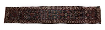 Lot 263 - Kurdish Runner Iranian Kurdistan, circa 1910 The midnight blue field with columns of polychrome...