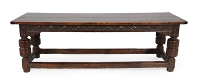 Lot 289 - A 17th Century Joined Oak Refectory Table, the four-plank top with cleated ends above a carved...