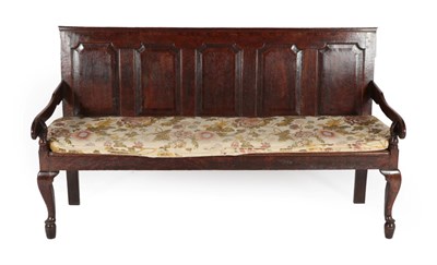 Lot 293 - A George III Joined Oak Settle, late 18th century, the back support with five fielded panels...