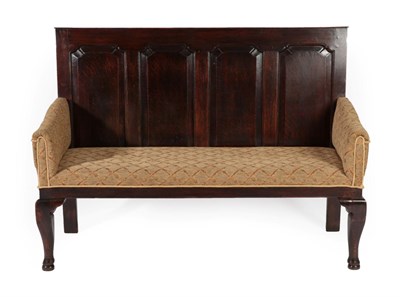 Lot 295 - A George III Oak Settle, late 18th/early 19th century, the back support with four fielded...