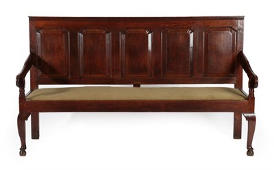 Lot 296 - A George III Joined Oak Settle, late 18th century, the back support with five moulded panels...