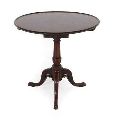 Lot 302 - A George III Mahogany Tripod Table, circa 1760, the circular top with moulded edge, on a turned...