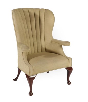 Lot 349 - A George III Style Wing-Back Armchair, 19th century, covered in green fabric with curved back...