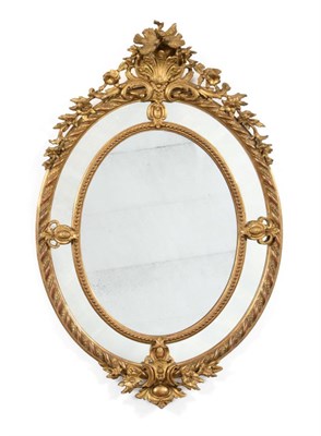 Lot 361 - A French Gilt and Gesso Oval Marginal Mirror, circa 1880, the original mirror plate within a beaded