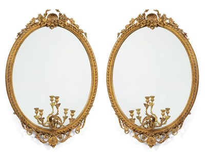 Lot 365 - A Pair of Gilt and Gesso Oval Mirrors, circa 1870, the mirror plates within a stiff leaf carved...