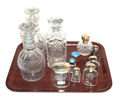 Lot 28 - A collection of silver-mounted cut-glass scent-bottles and jars, including two with pale blue...