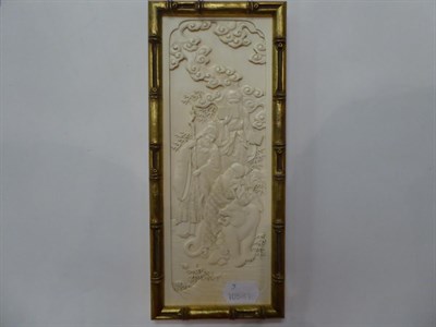 Lot 31 - Three early 20th century carved ivory plaques; and a smaller ebonised example