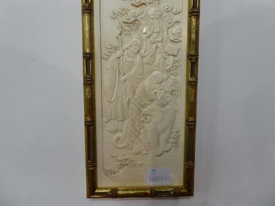 Lot 31 - Three early 20th century carved ivory plaques; and a smaller ebonised example