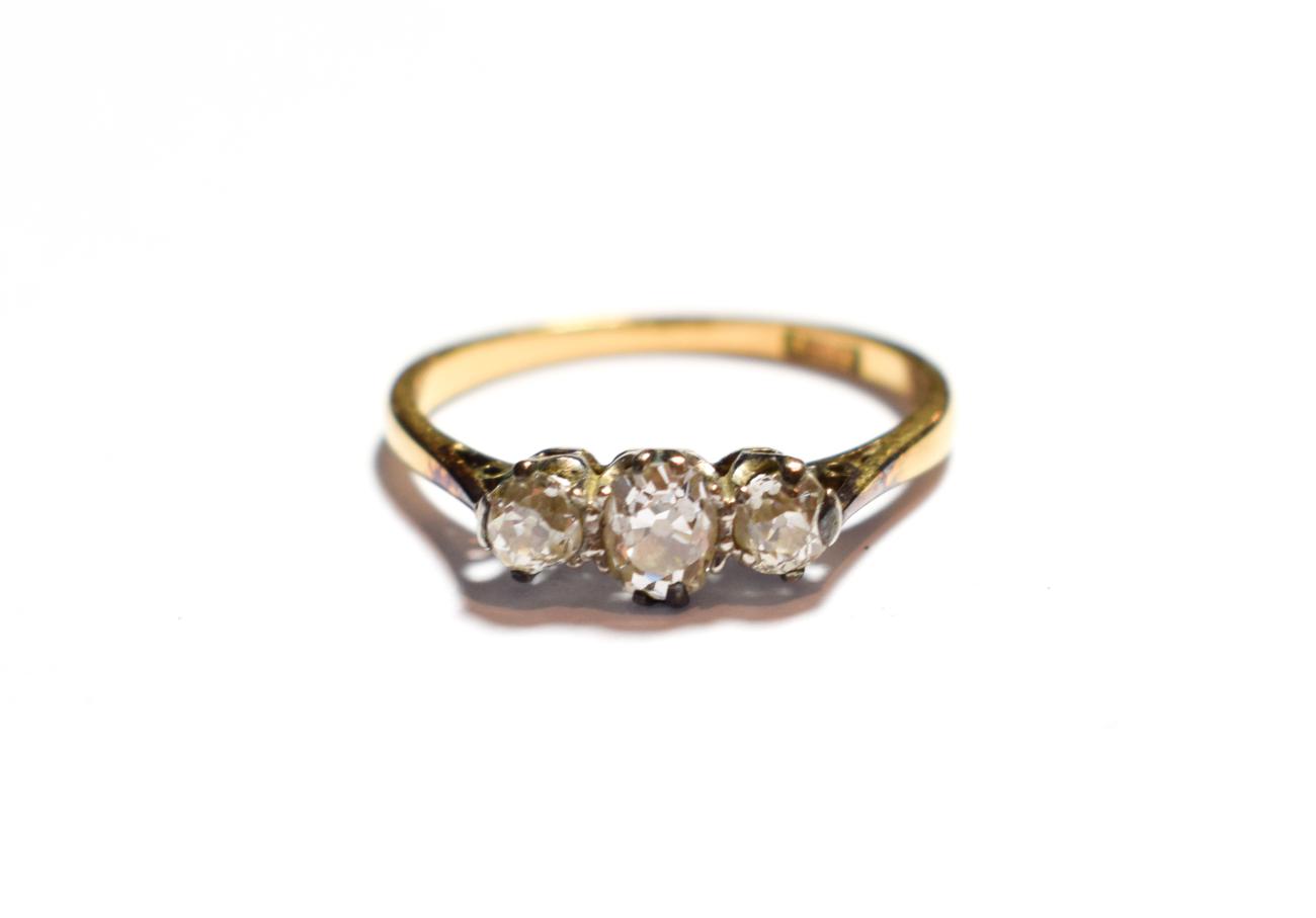 Lot 59 - A diamond three stone ring, stamped '18CT', finger size N1/2