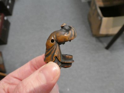 Lot 65 - A Japanese wood netsuke, 19th century, as a crouching figure peering into a brazier, signed,...