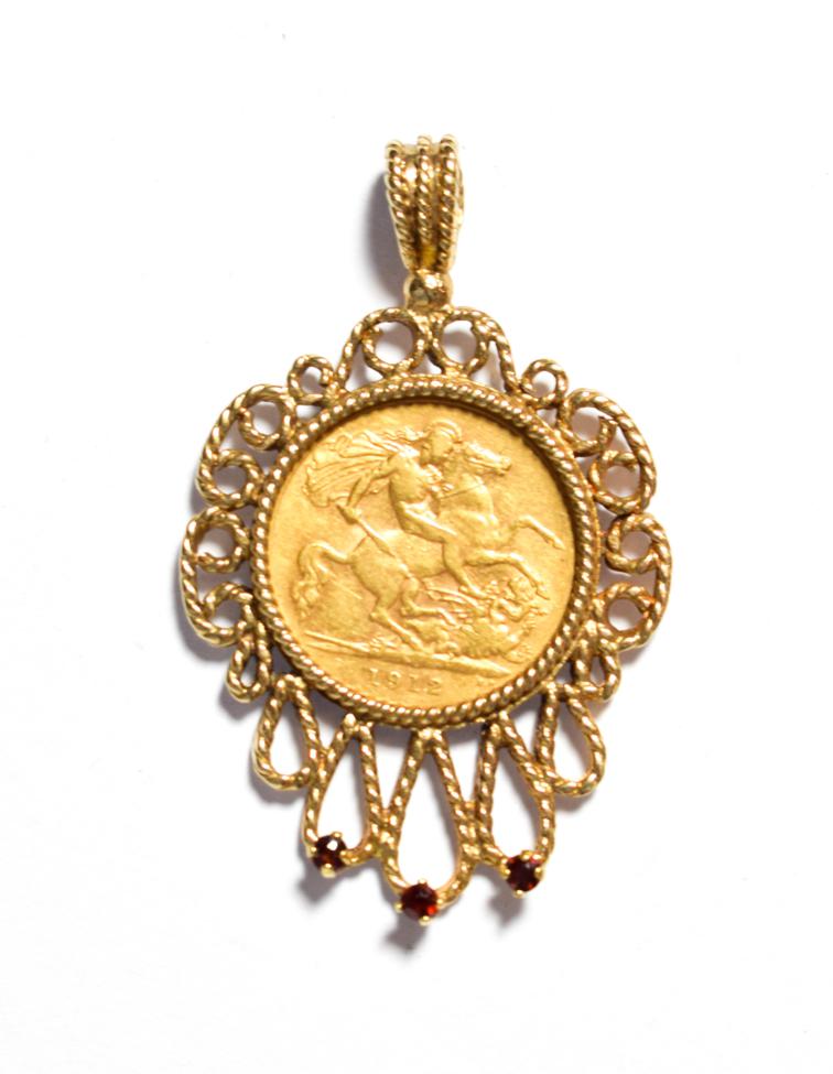Lot 80 - A 1912 half sovereign loose mounted as a pendant in a gemset frame, length 4.5cm