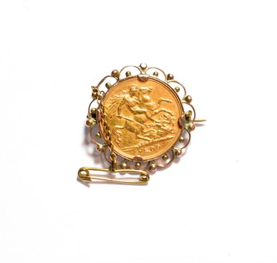 Lot 88 - An Edward VII 1909 half sovereign loose mounted as a brooch