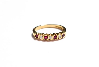 Lot 95 - A 9 carat gold ruby and diamond half hoop ring, total estimated diamond weight 0.15 carat...