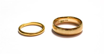 Lot 104 - A 9 carat gold band ring, finger size T; and a 22 carat gold band ring, finger size L1/2