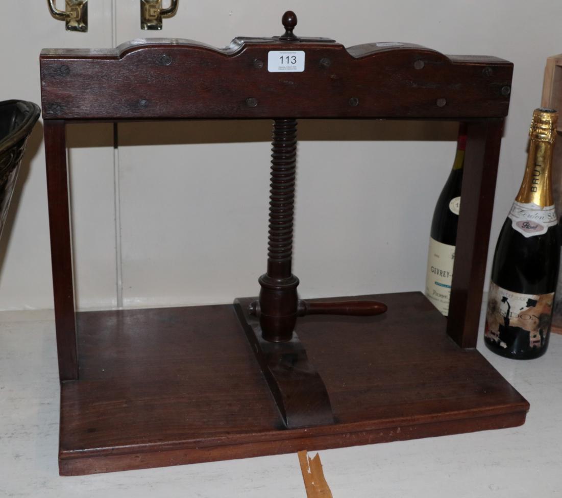 Lot 113 - An early 19th century mahogany press with turned handle