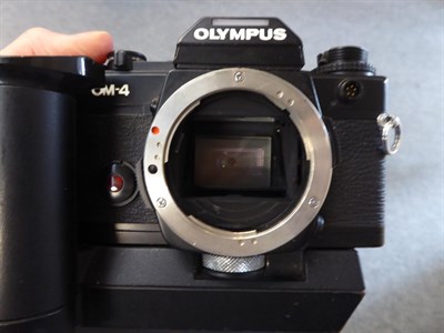 Lot 125 - A bag of cameras including Olympus OM4