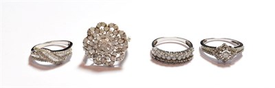 Lot 170 - A large silver diamond set cluster ring, finger size R1/2; and three other silver diamond set rings