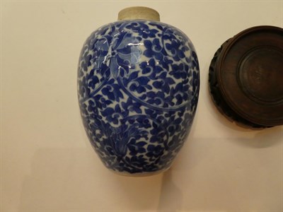 Lot 211 - A Chinese blue and white floral decorated vase with a pierced hardwood stand