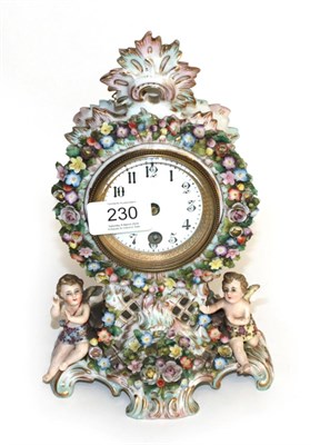 Lot 230 - A floral encrusted porcelain mantel timepiece, early 20th century