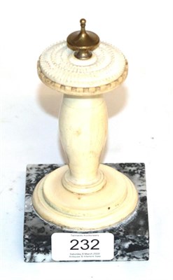 Lot 232 - A carved ivory ornament in the form of a sundial raised on a marble base