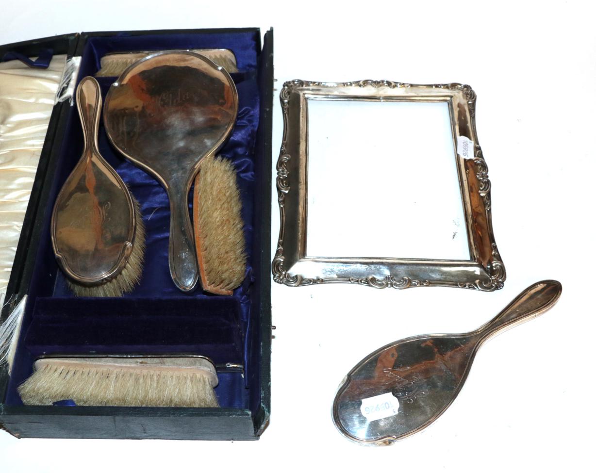 Lot 237 - A silver-backed five-piece dressing-table service, comprising: three brushes; two hand mirrors;...