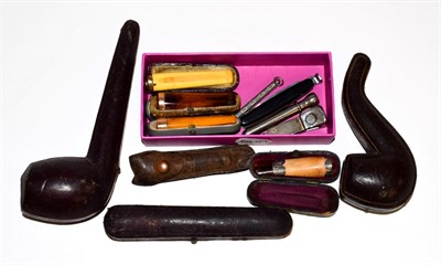 Lot 296 - Three gold mounted amber cheroot holders, a large amber cheroot holder, silver mounted example, two