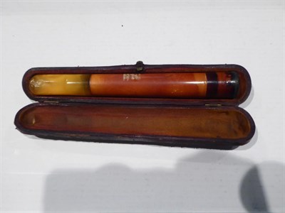 Lot 296 - Three gold mounted amber cheroot holders, a large amber cheroot holder, silver mounted example, two