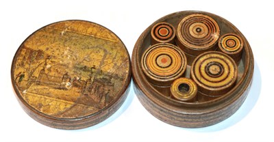 Lot 368 - A late Georgian treen circular box decorated with a landscape, enclosing six smaller boxes