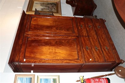 Lot 1205 - A Victorian mahogany linen press with cupboard doors enclosing two sliding trays and a pole,...
