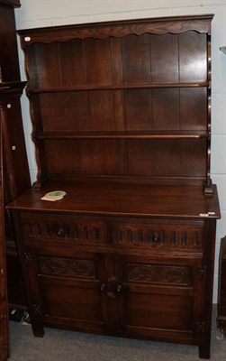 Lot 1211 - A reproduction oak Welsh dresser with rack, 107cm wide